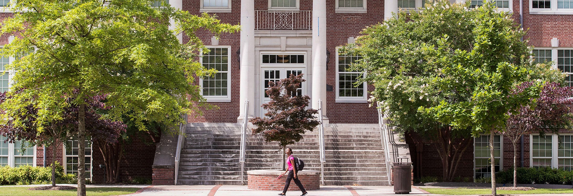 Image of one student walking in front of the Flanagan Building